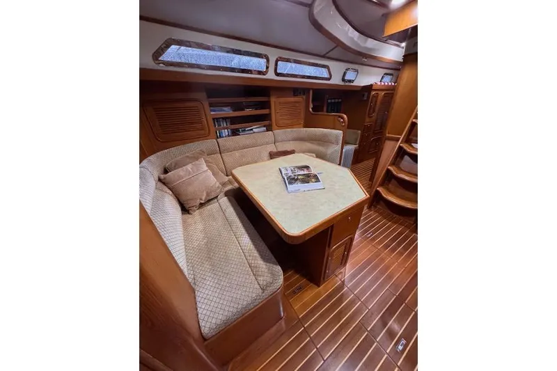 Slide: The Image of 2006 Tayana Deck Salon interior with cozy seating and wooden finishes. - 3