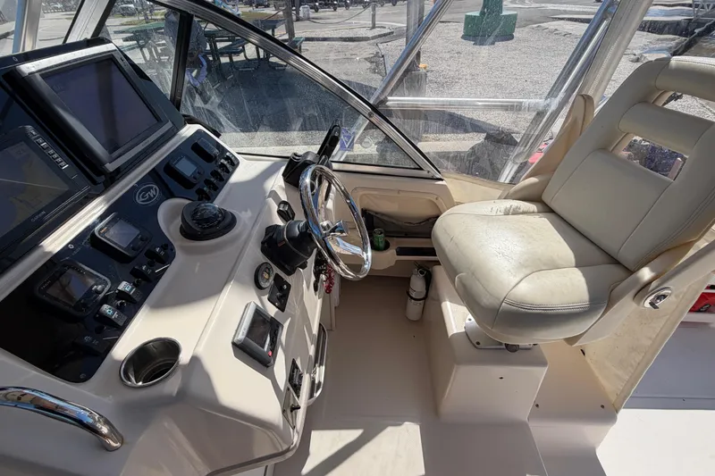 Slide: The Image of 2006 Grady-White Sailfish 282 helm with navigation equipment and captain's chair. - 100