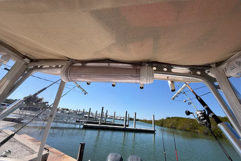Slide: The Image of 2006 Grady-White Sailfish 282 boat interior with fishing rods and marina view. - 103