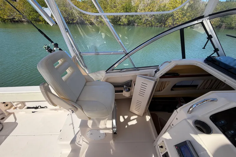 Slide: The Image of 2006 Grady-White Sailfish 282 boat interior with helm seat and cabin entrance. - 104