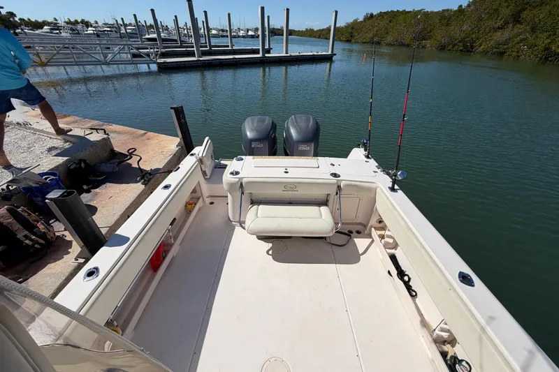Slide: The Image of 2006 Grady-White Sailfish 282 boat docked, featuring fishing rods and dual engines. - 106