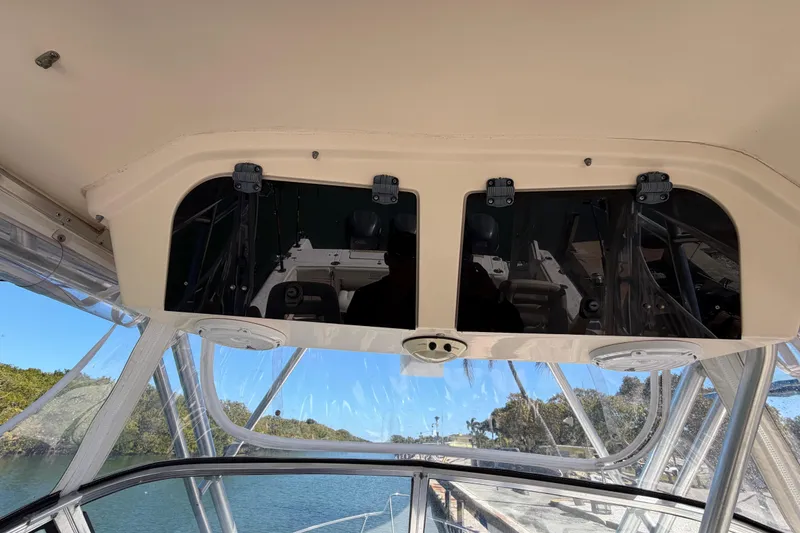 Slide: The Image of 2006 Grady-White Sailfish 282 boat interior with overhead storage and clear canopy view. - 108