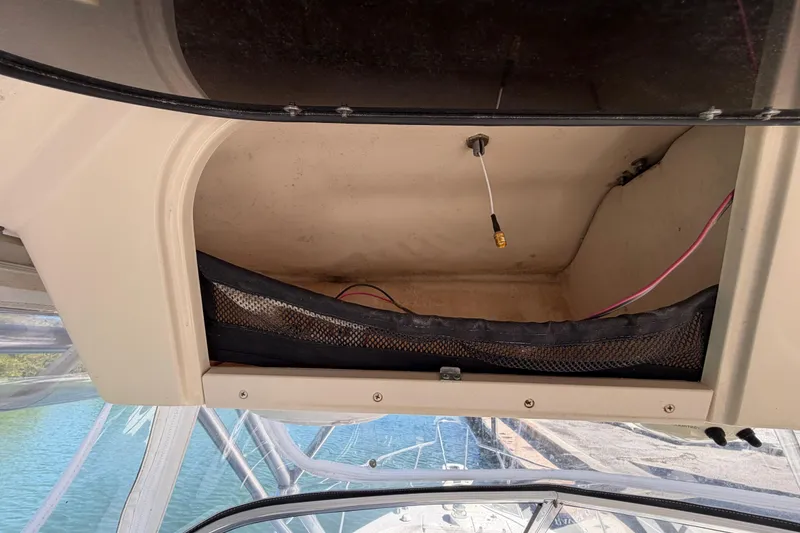 Slide: The Image of Open storage compartment on 2006 Grady-White Sailfish 282 boat with wiring visible. - 110