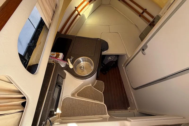 Slide: The Image of 2006 Grady-White Sailfish 282 cabin interior with kitchenette and seating area. - 116