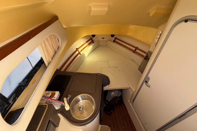 Slide: The Image of 2006 Grady-White Sailfish 282 cabin interior with kitchenette and seating area. - 117