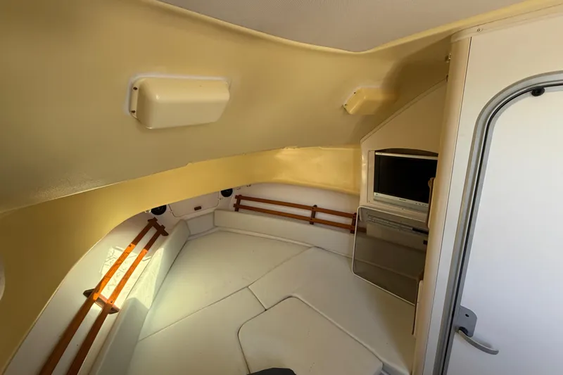 Slide: The Image of 2006 Grady-White Sailfish 282 cabin interior with TV and seating area. - 119