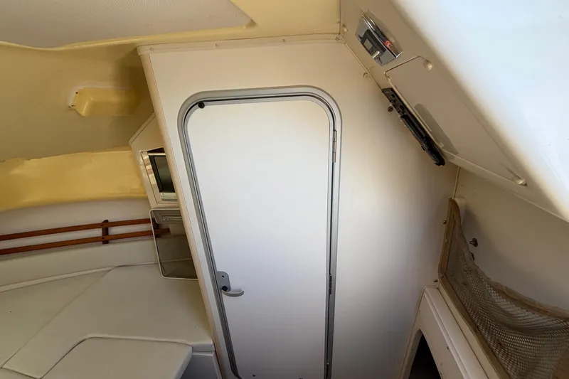 Slide: The Image of 2006 Grady-White Sailfish 282 cabin interior with door and seating area. - 120