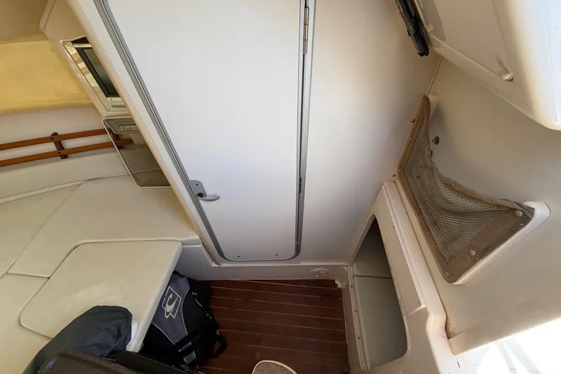 Slide: The Image of 2006 Grady-White Sailfish 282 cabin interior with seating and storage areas. - 121