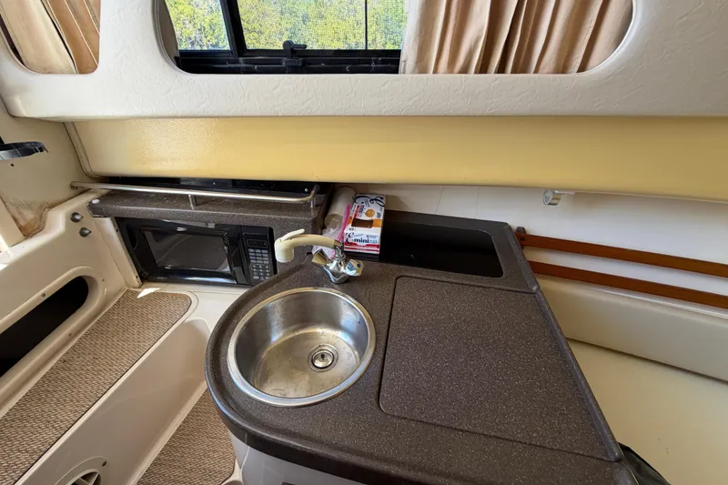 Slide: The Image of 2006 Grady-White Sailfish 282 interior with sink, microwave, and countertop. - 122