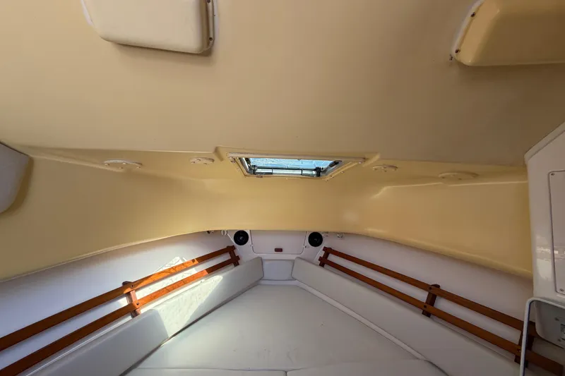 Slide: The Image of 2006 Grady-White Sailfish 282 cabin interior with wood accents and overhead hatch. - 124