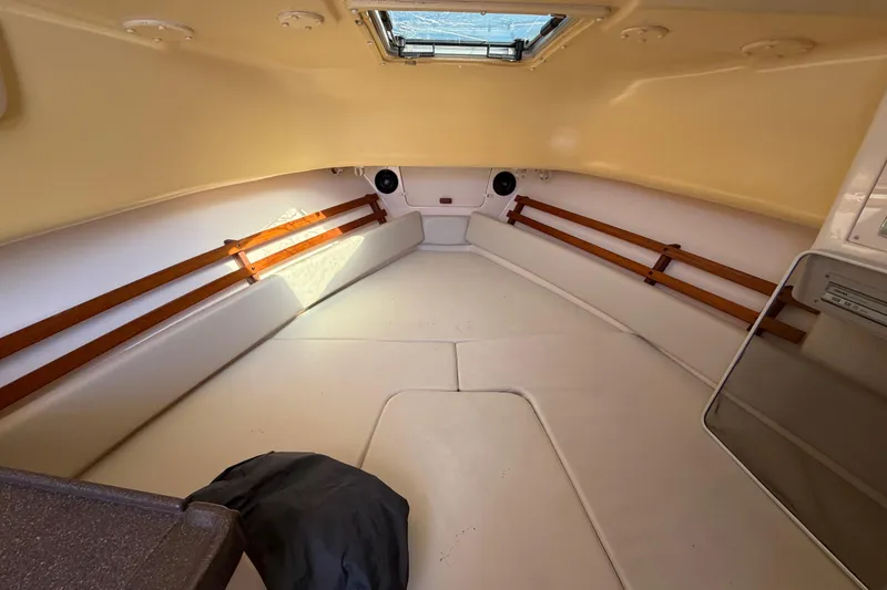 Slide: The Image of 2006 Grady-White Sailfish 282 cabin interior with beige upholstery and wooden accents. - 125