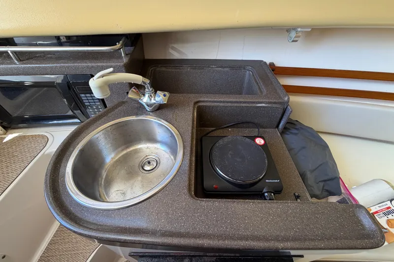 Slide: The Image of 2006 Grady-White Sailfish 282 boat kitchenette with sink, faucet, and hot plate. - 129