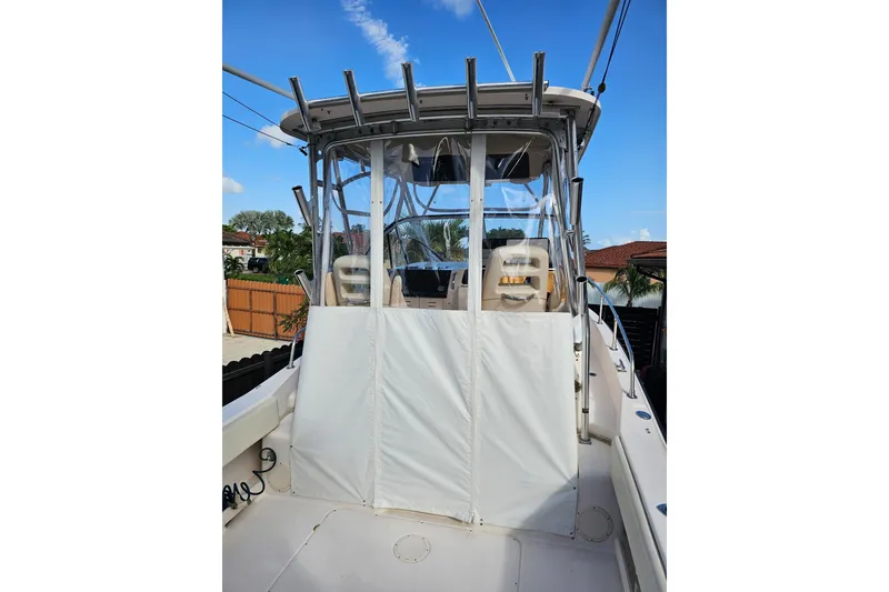 Slide: The Image of 2006 Grady-White Sailfish 282 boat with enclosed helm, clear skies in background. - 13