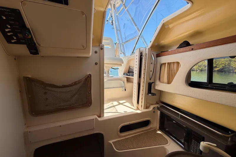 Slide: The Image of Interior of 2006 Grady-White Sailfish 282 boat, featuring cabin amenities and natural light. - 131