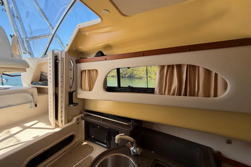 Slide: The Image of 2006 Grady-White Sailfish 282 cabin interior with window, sink, and microwave. - 132
