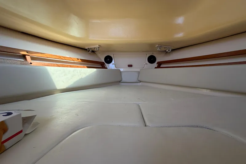Slide: The Image of Interior cabin of 2006 Grady-White Sailfish 282 boat, featuring cushioned seating and wooden accents. - 134