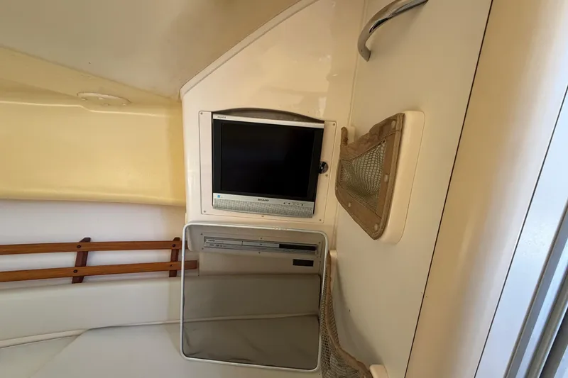 Slide: The Image of Interior of 2006 Grady-White Sailfish 282 with TV and storage compartments. - 135