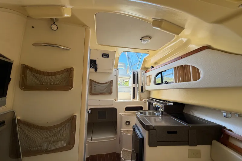 Slide: The Image of 2006 Grady-White Sailfish 282 cabin interior with kitchenette and storage compartments. - 136