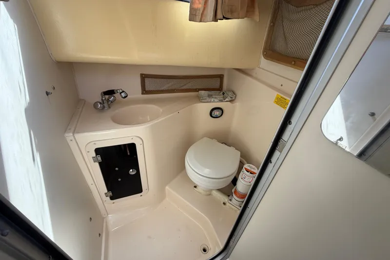 Slide: The Image of 2006 Grady-White Sailfish 282 boat bathroom with sink, toilet, and storage. - 139