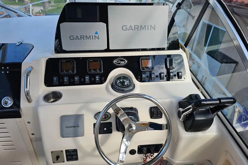 Slide: The Image of 2006 Grady-White Sailfish 282 helm with Garmin navigation system and steering wheel. - 14