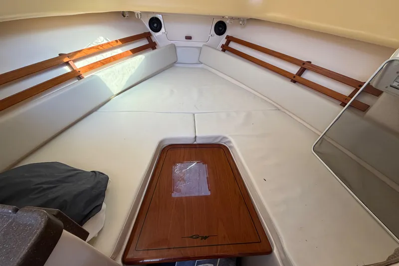 Slide: The Image of 2006 Grady-White Sailfish 282 cabin interior with wood accents and cushioned seating. - 141