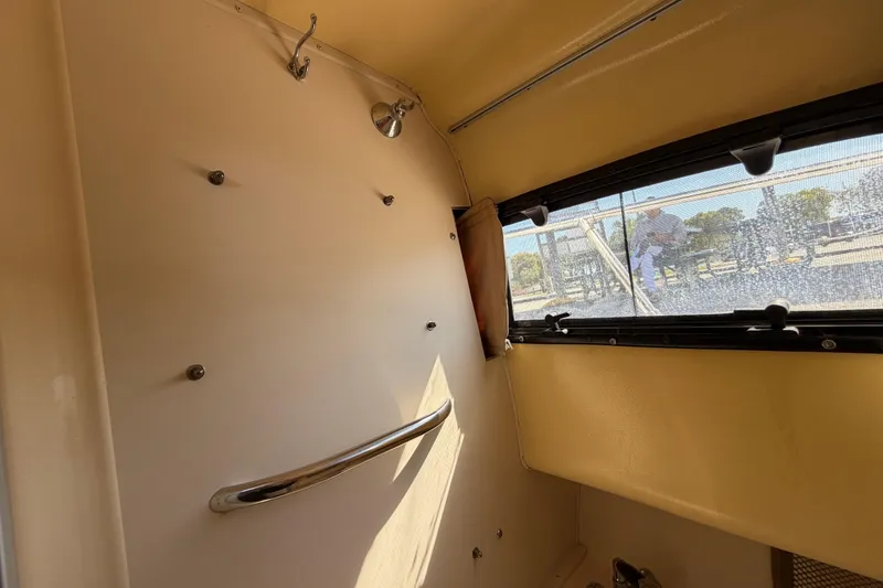 Slide: The Image of Interior view of 2006 Grady-White Sailfish 282 boat cabin with window and handrail. - 142