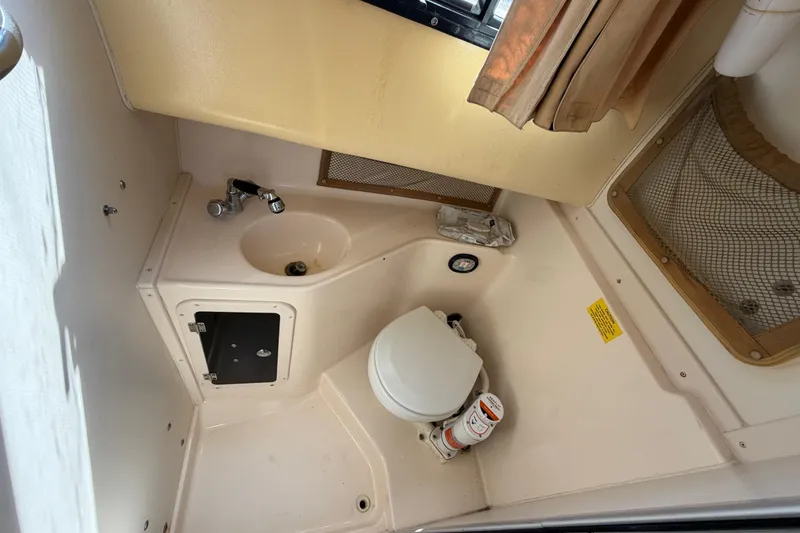 Slide: The Image of 2006 Grady-White Sailfish 282 boat bathroom with sink, toilet, and storage. - 144