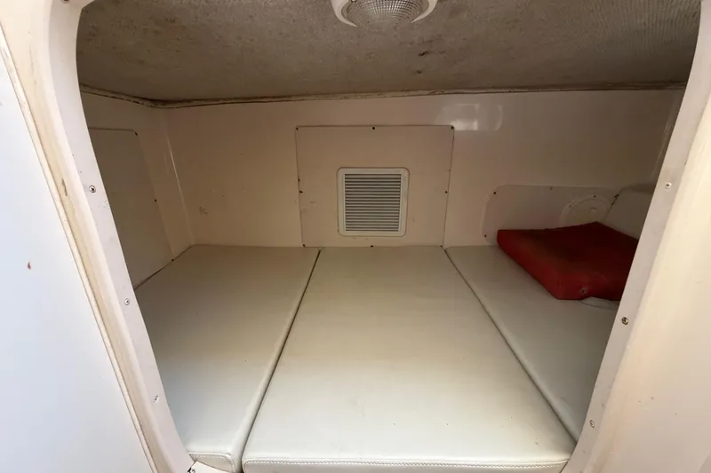 Slide: The Image of 2006 Grady-White Sailfish 282 cabin interior with cushioned sleeping area. - 145