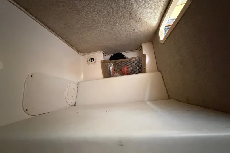 Slide: The Image of Interior cabin of 2006 Grady-White Sailfish 282 boat, featuring storage and window. - 154