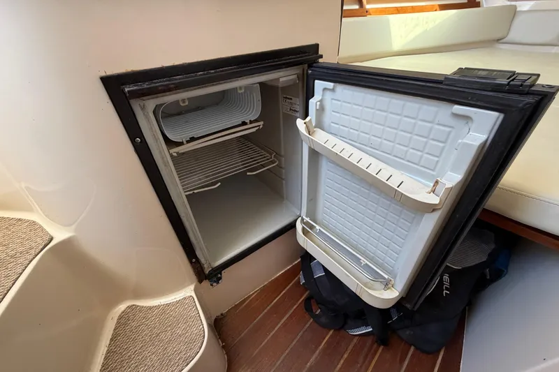 Slide: The Image of 2006 Grady-White Sailfish 282 boat interior with open mini fridge. - 157