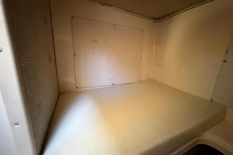 Slide: The Image of 2006 Grady-White Sailfish 282 cabin interior with white cushioned seating. - 159