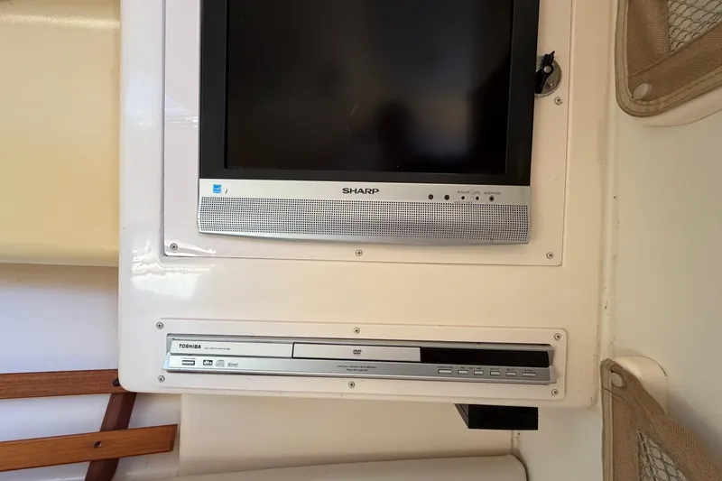 Slide: The Image of Sharp TV and Toshiba DVD player inside 2006 Grady-White Sailfish 282 boat cabin. - 160