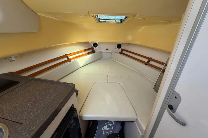 Slide: The Image of 2006 Grady-White Sailfish 282 cabin interior with cushioned seating and compact kitchenette. - 161