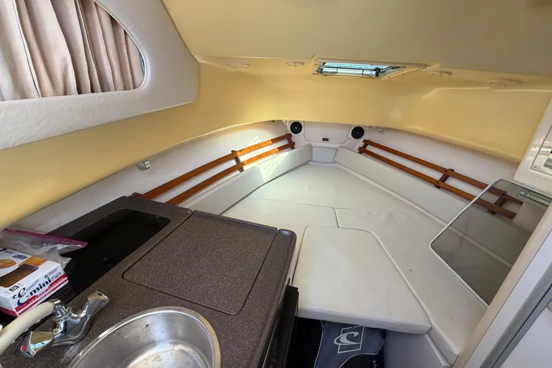 Slide: The Image of 2006 Grady-White Sailfish 282 cabin interior with kitchenette and seating area. - 166