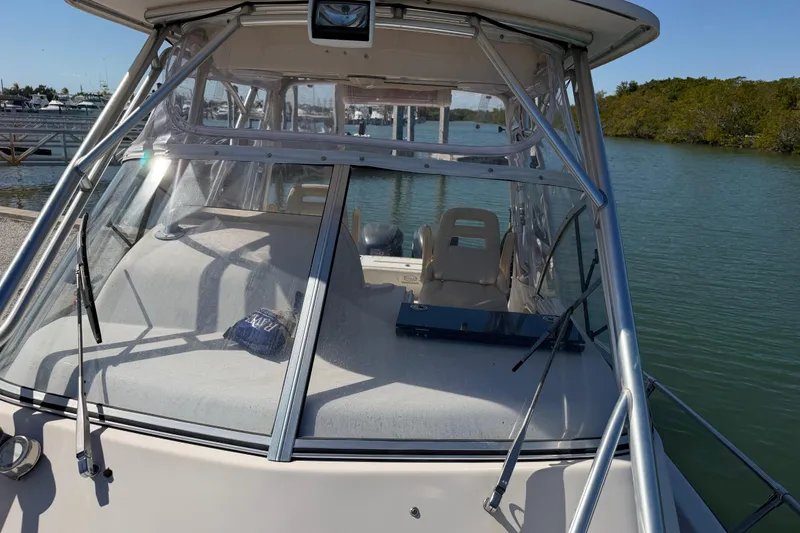 Slide: The Image of 2006 Grady-White Sailfish 282 boat docked by the water, featuring a spacious cockpit. - 168