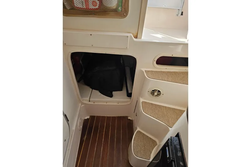 Slide: The Image of Interior view of 2006 Grady-White Sailfish 282 boat with steps and storage compartment. - 17