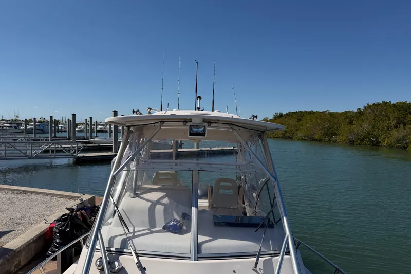 Slide: The Image of 2006 Grady-White Sailfish 282 boat docked in a serene marina setting. - 173