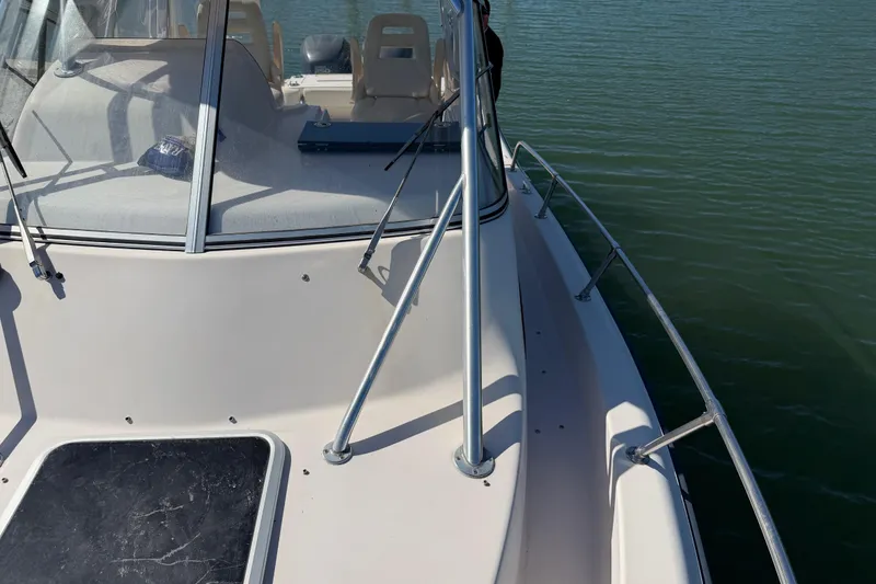 Slide: The Image of 2006 Grady-White Sailfish 282 boat deck with windshield and railing on water. - 178