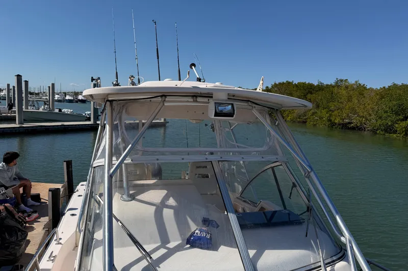 Slide: The Image of 2006 Grady-White Sailfish 282 boat docked by a marina, clear blue sky. - 179