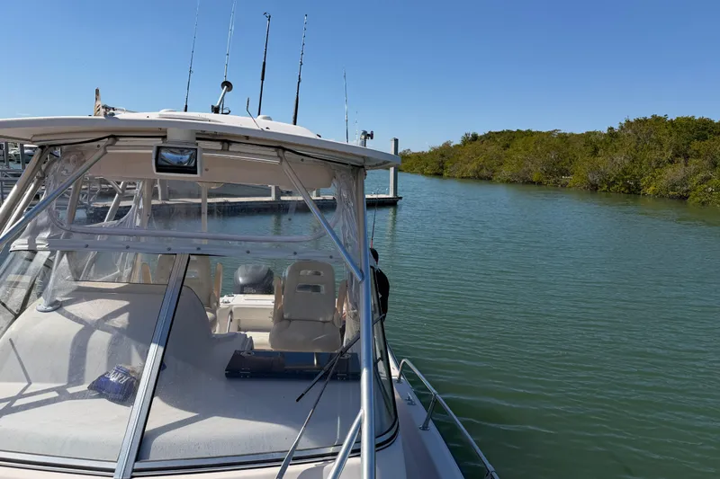 Slide: The Image of 2006 Grady-White Sailfish 282 boat docked on a calm, sunny waterway. - 183