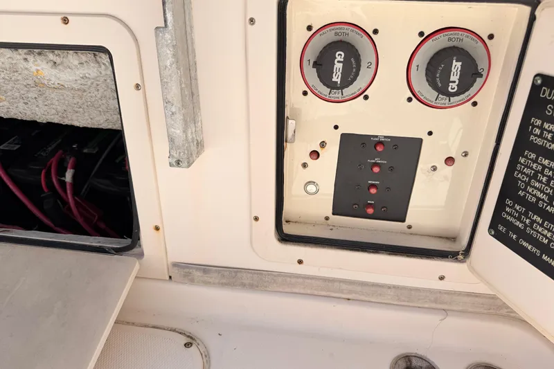 Slide: The Image of Control panel of a 2006 Grady-White Sailfish 282 boat, featuring battery switches and wiring. - 188