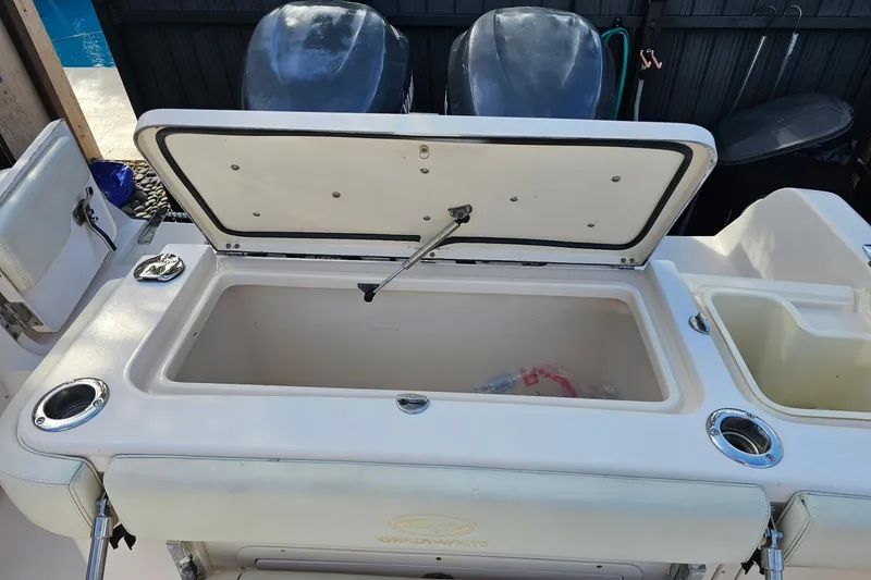 Slide: The Image of Open storage compartment on 2006 Grady-White Sailfish 282 boat, featuring dual outboard motors. - 19