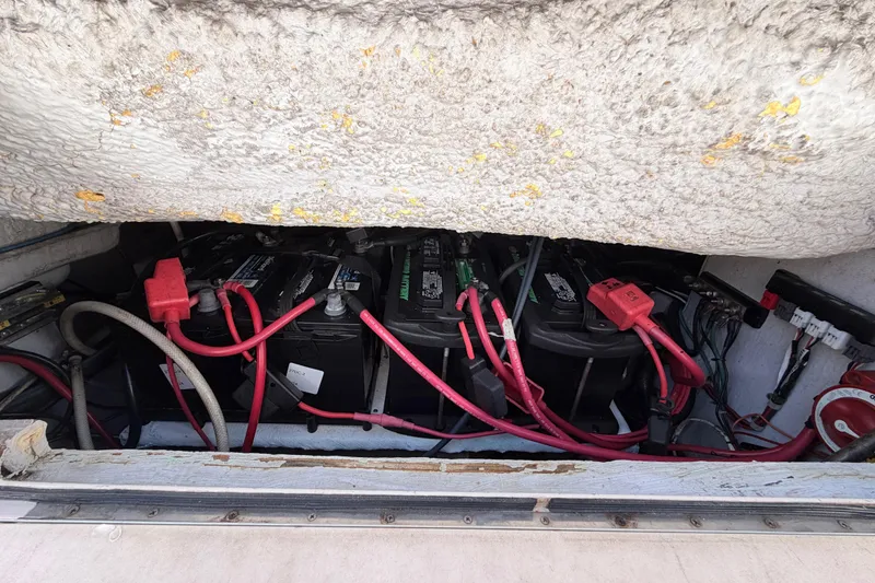 Slide: The Image of Battery compartment of 2006 Grady-White Sailfish 282 with red and black cables. - 191