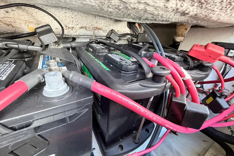 Slide: The Image of Battery compartment of 2006 Grady-White Sailfish 282 with red cables and connectors. - 198
