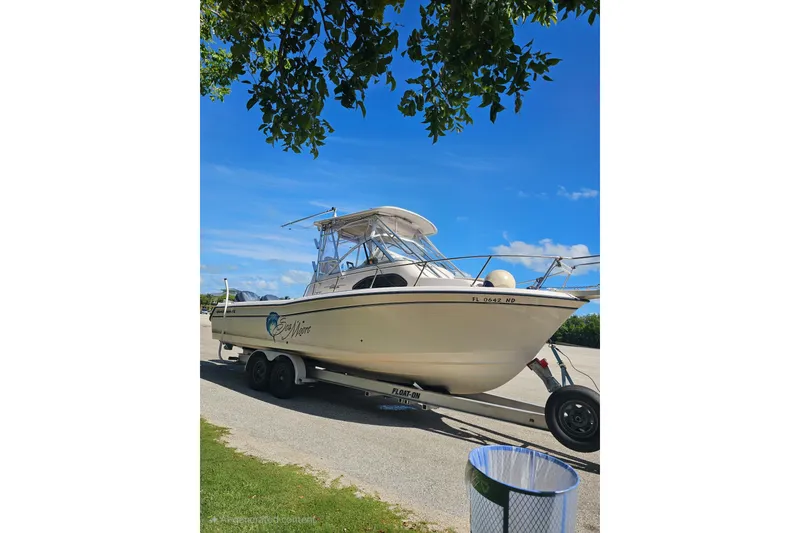 Slide: The Image of 2006 Grady-White Sailfish 282 boat on trailer under clear blue sky. - 2