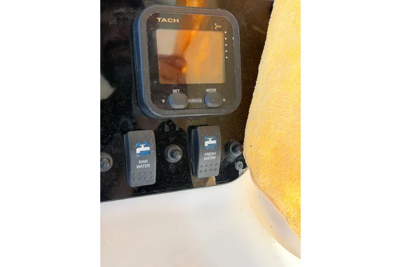 Slide: The Image of Control panel of 2006 Grady-White Sailfish 282 boat with water switches and tachometer. - 209