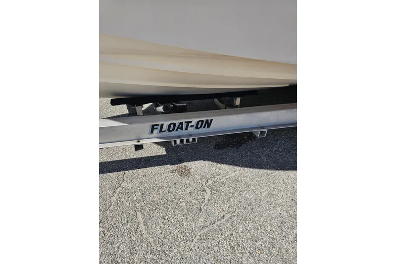 Slide: The Image of 2006 Grady-White Sailfish 282 on a Float-On trailer, parked on asphalt. - 23