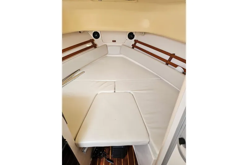 Slide: The Image of 2006 Grady-White Sailfish 282 cabin interior with cushioned seating and wooden accents. - 24