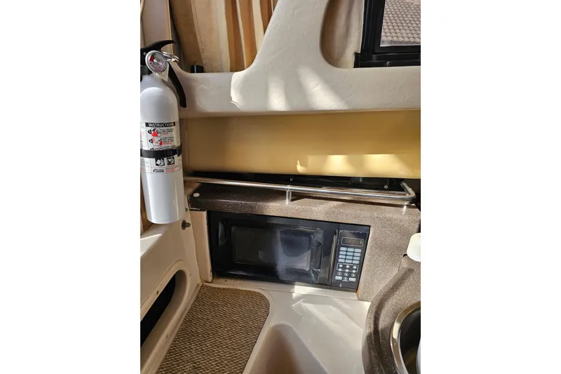 Slide: The Image of 2006 Grady-White Sailfish 282 interior with microwave and fire extinguisher. - 26