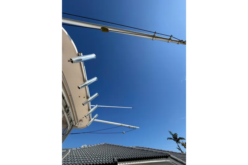 Slide: The Image of 2006 Grady-White Sailfish 282 boat outriggers against clear blue sky. - 38